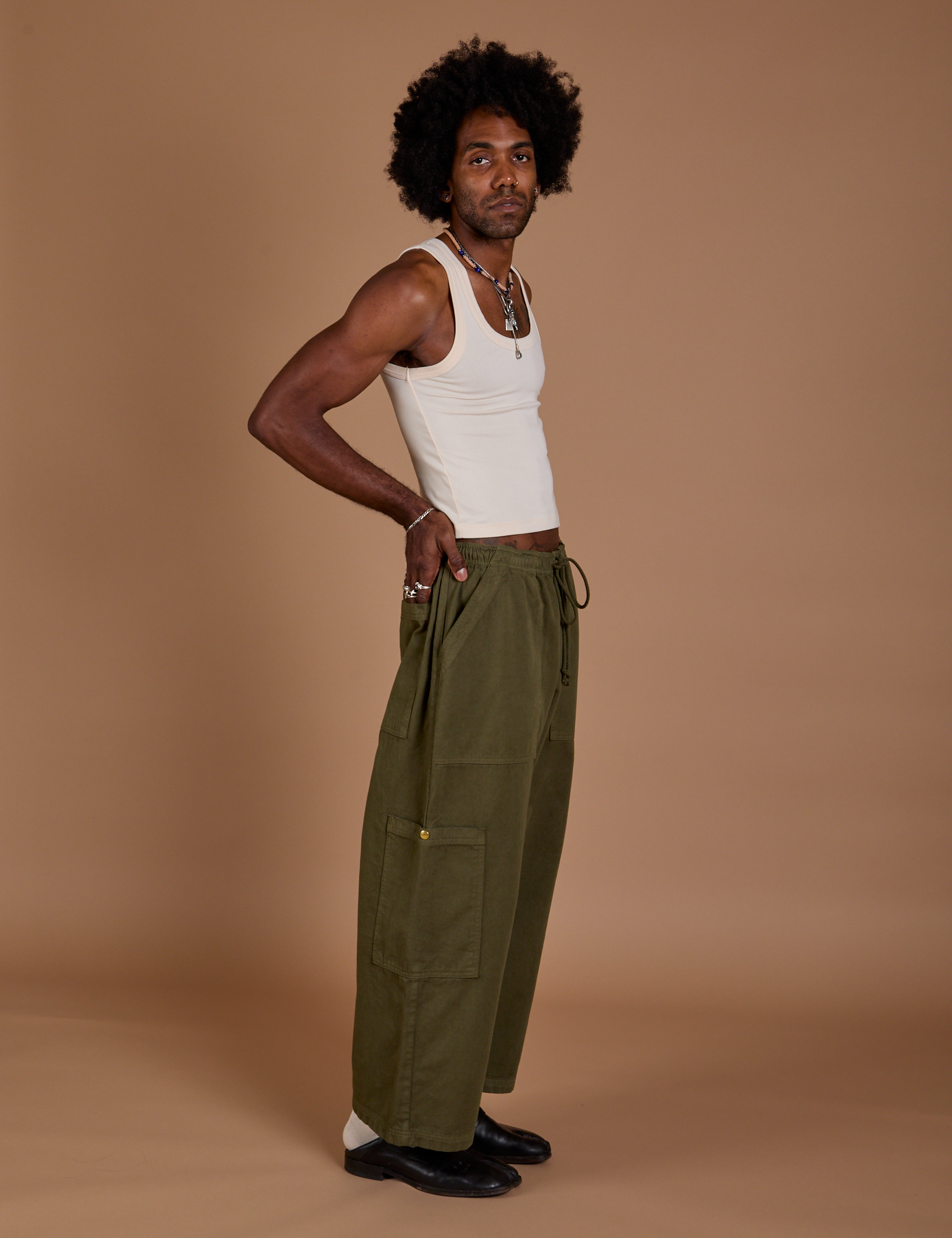 Side view of Drop Pocket Cargo Pants in Surplus Green and Tank Top in Vintage Tee White