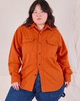 Ashley is wearing a buttoned up Flannel Overshirt in Burnt Orange