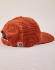 Side view of Dugout Corduroy Hat in Burnt Terracotta. Big Bud label sewn on edge of hat.