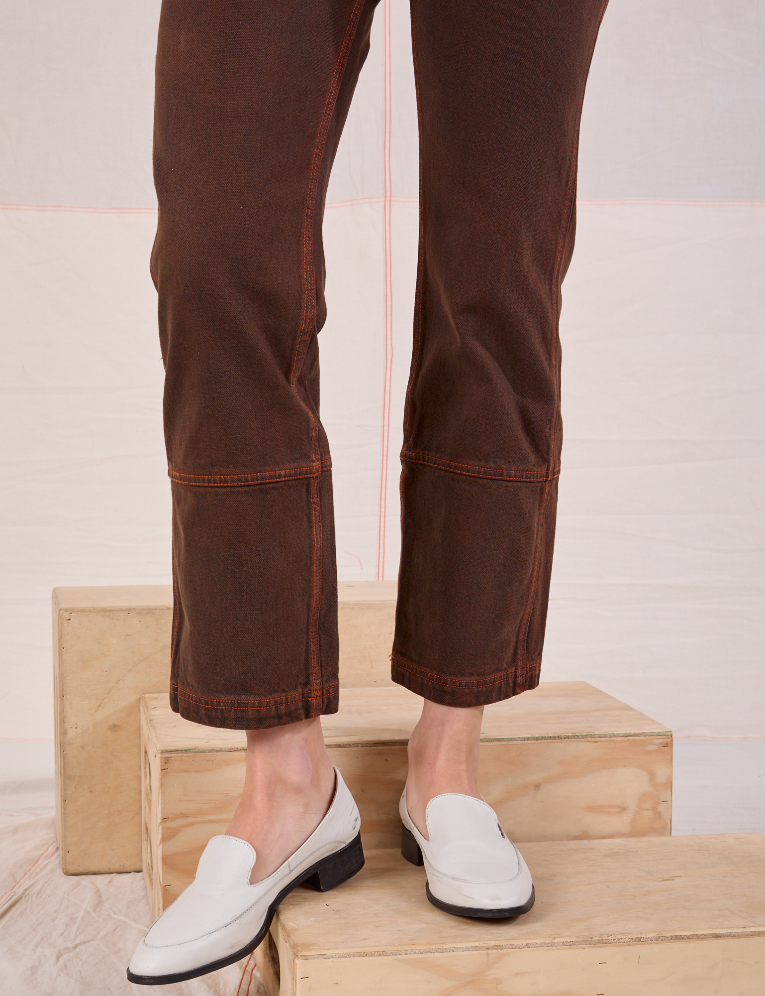 Overdyed Carpenter Jeans in Fudge pant leg close up on Alex