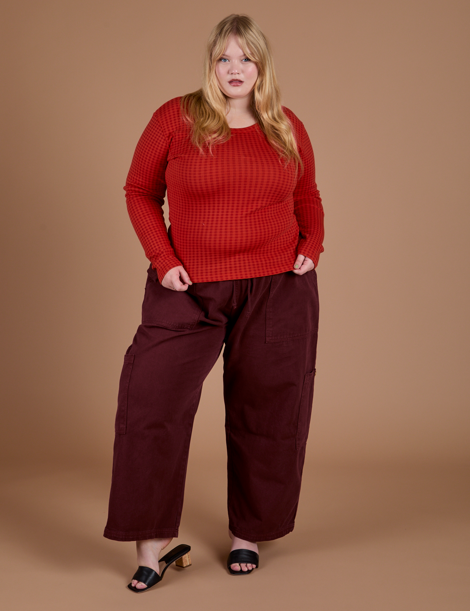 Juliet is wearing Gingham Long Sleeve Baby Tee in Mustang Red paired with red wine Drop Pocket Cargo Pants