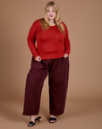 Juliet is wearing Gingham Long Sleeve Baby Tee in Mustang Red paired with red wine Drop Pocket Cargo Pants
