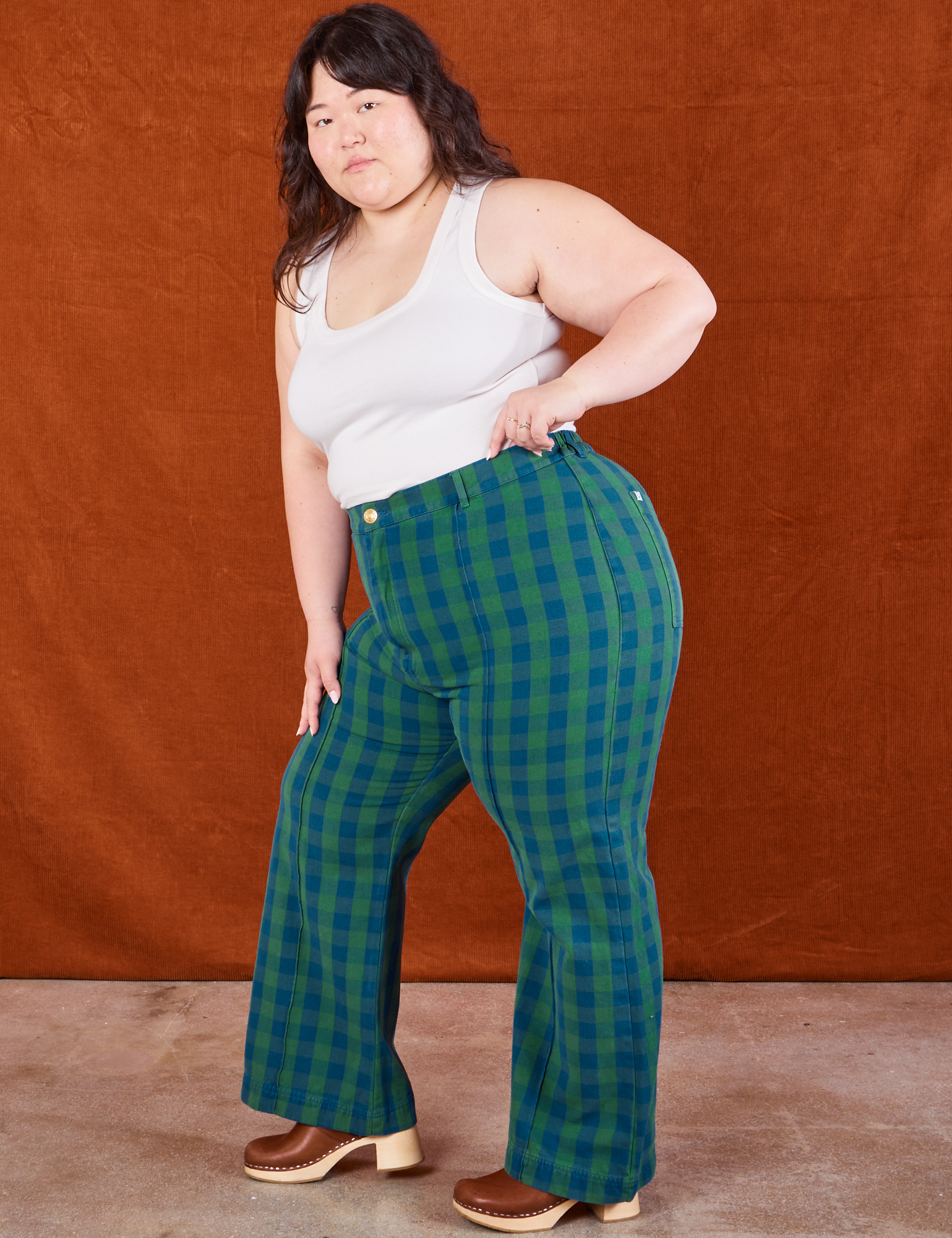 Side view of Gingham Western Pants in Green and Cropped Tank in vintage tee off-white