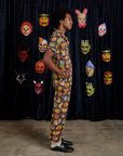 Side view of Short Sleeve Jumpsuit in Halloween Masks on Jerrod