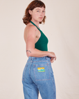 Side view of Halter Top in Hunter Green worn by Alex paired with light wash Frontier Jeans