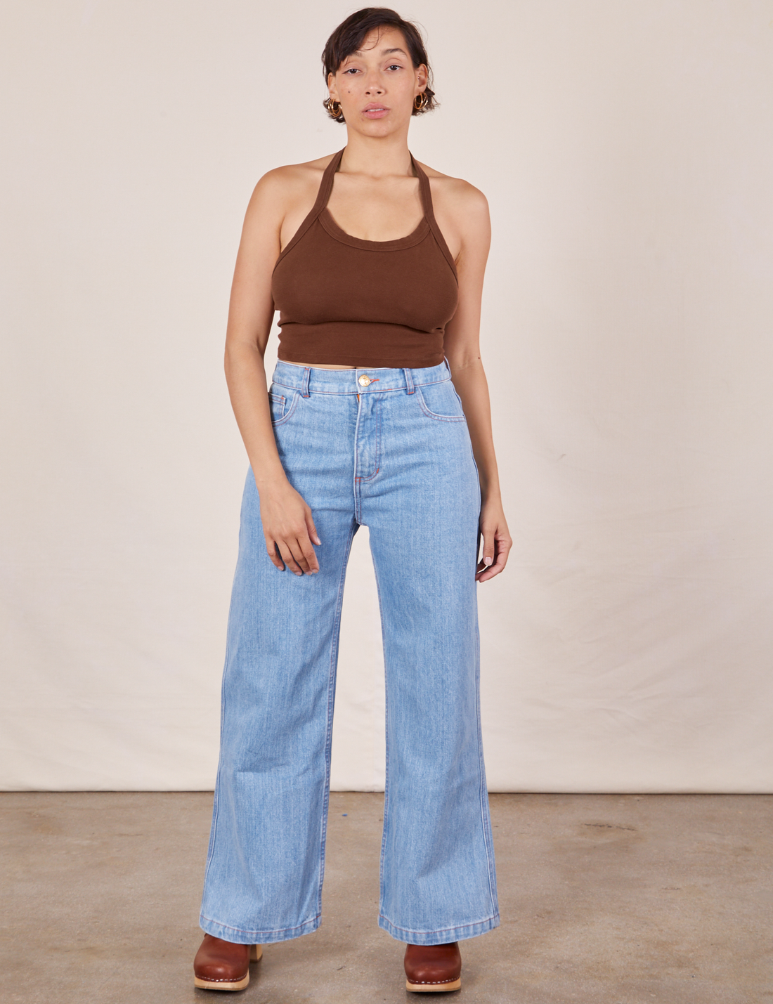 Tiara is 5'4" and wearing XS Halter Top in Fudgesicle Brown and light wash Sailor Jeans