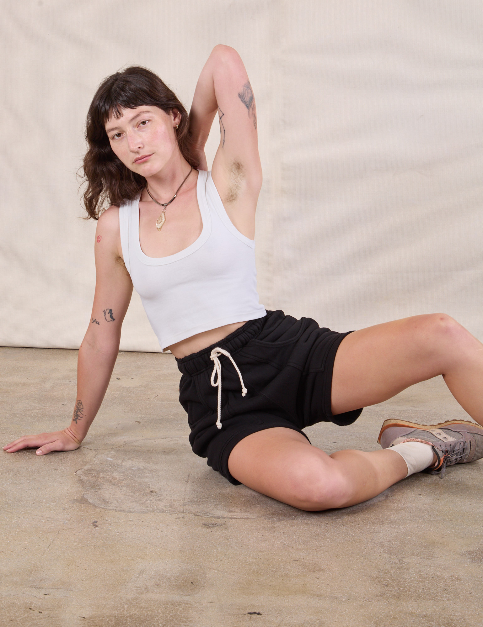 Heavyweight Sweat Shorts in Basic Black and Cropped Tank in Vintage Tee Off-White worn by Alex