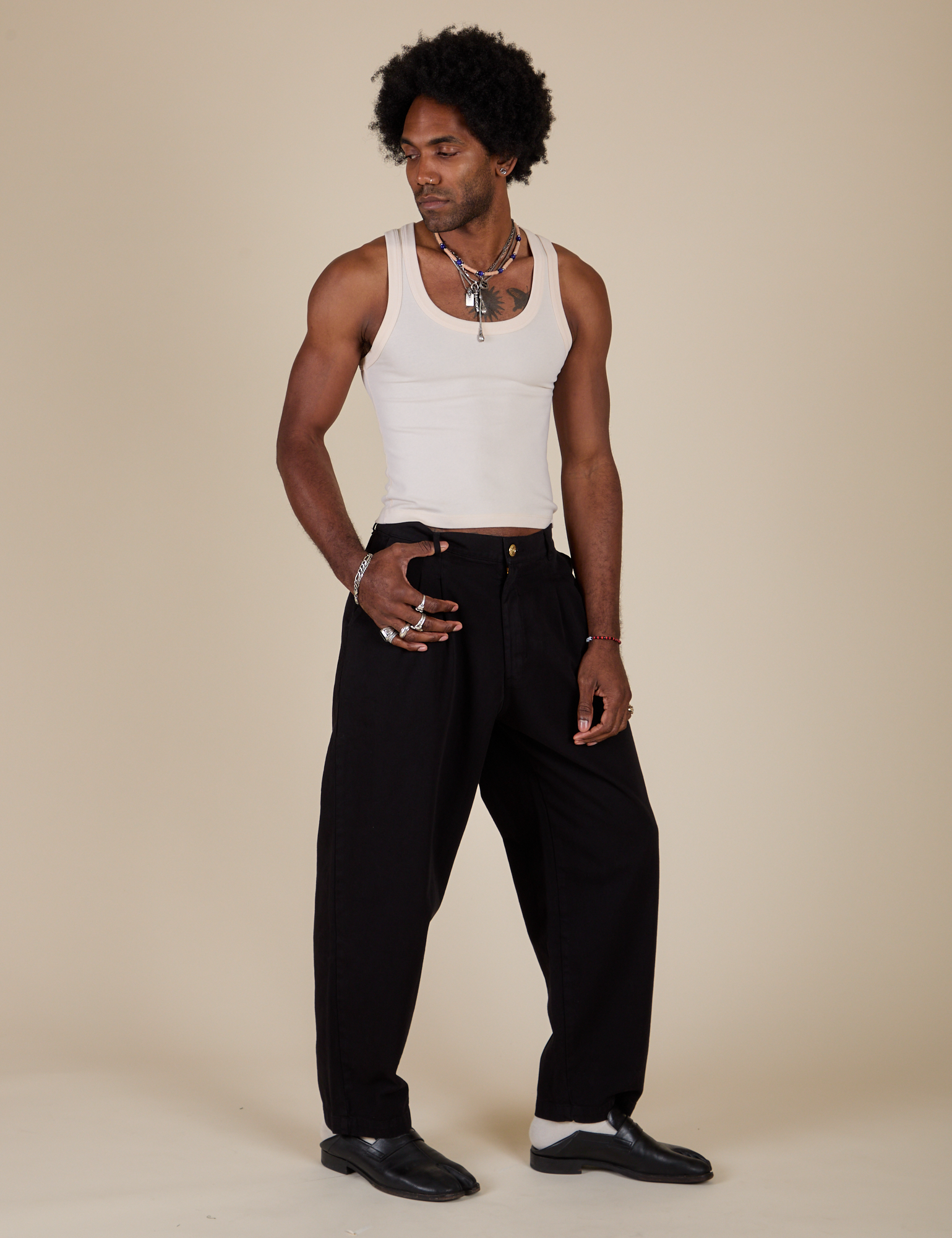 Angled front view of Heavyweight Trousers in Basic Black and Tank Top in Vintage Tee Off-White