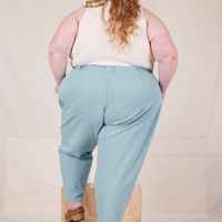 Back view of Heavyweight Trousers in Baby Blue and vintage off-white Sleeveless Turtleneck worn by Catie