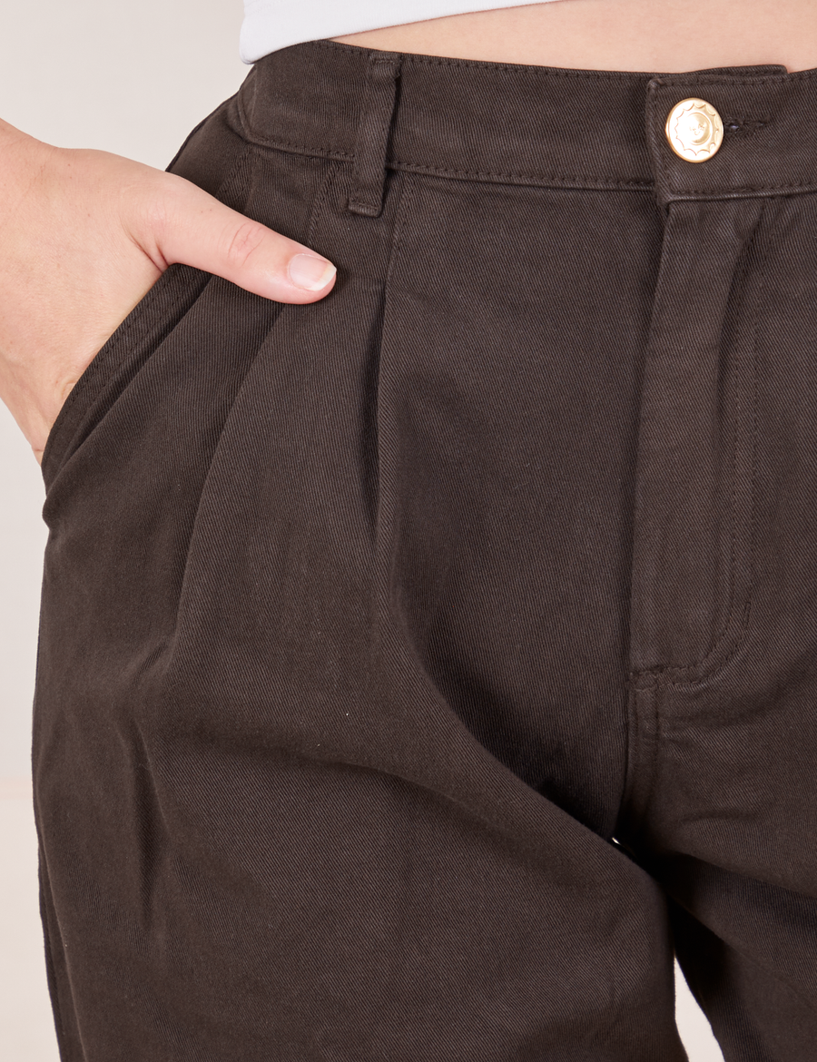 Front close up of Heavyweight Trousers in Espresso Brown. Alex has her hand in the pocket.