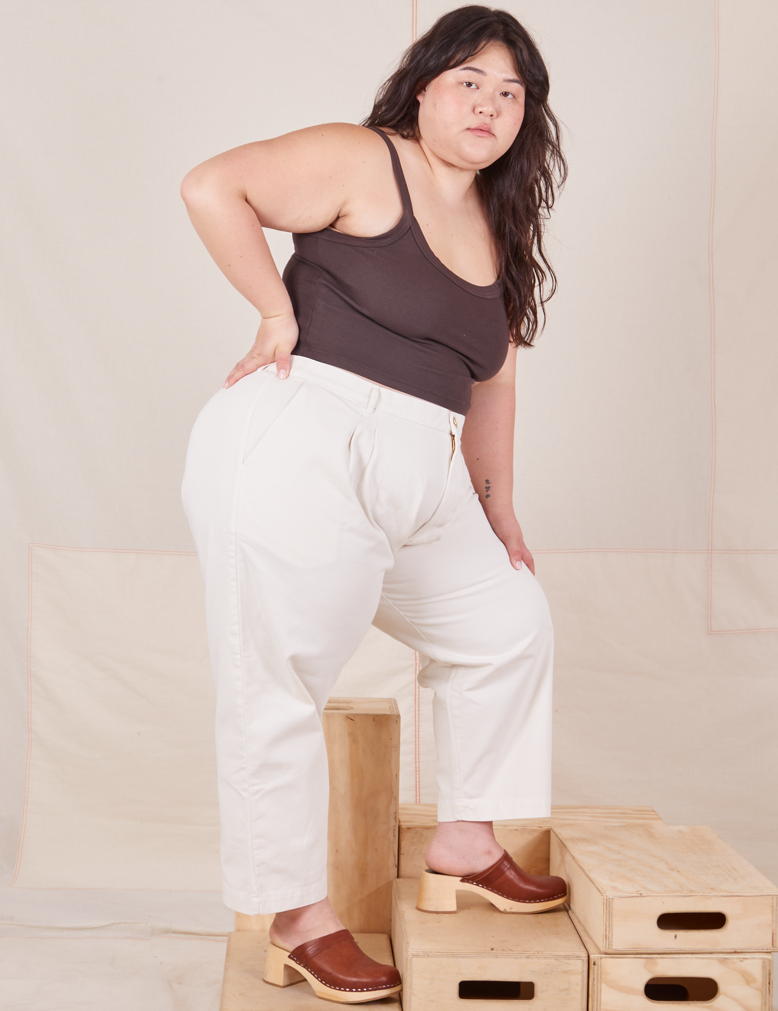 Side view of Heavyweight Trousers in Vintage Off-White and espresso brown Cropped Cami worn by Ashley.