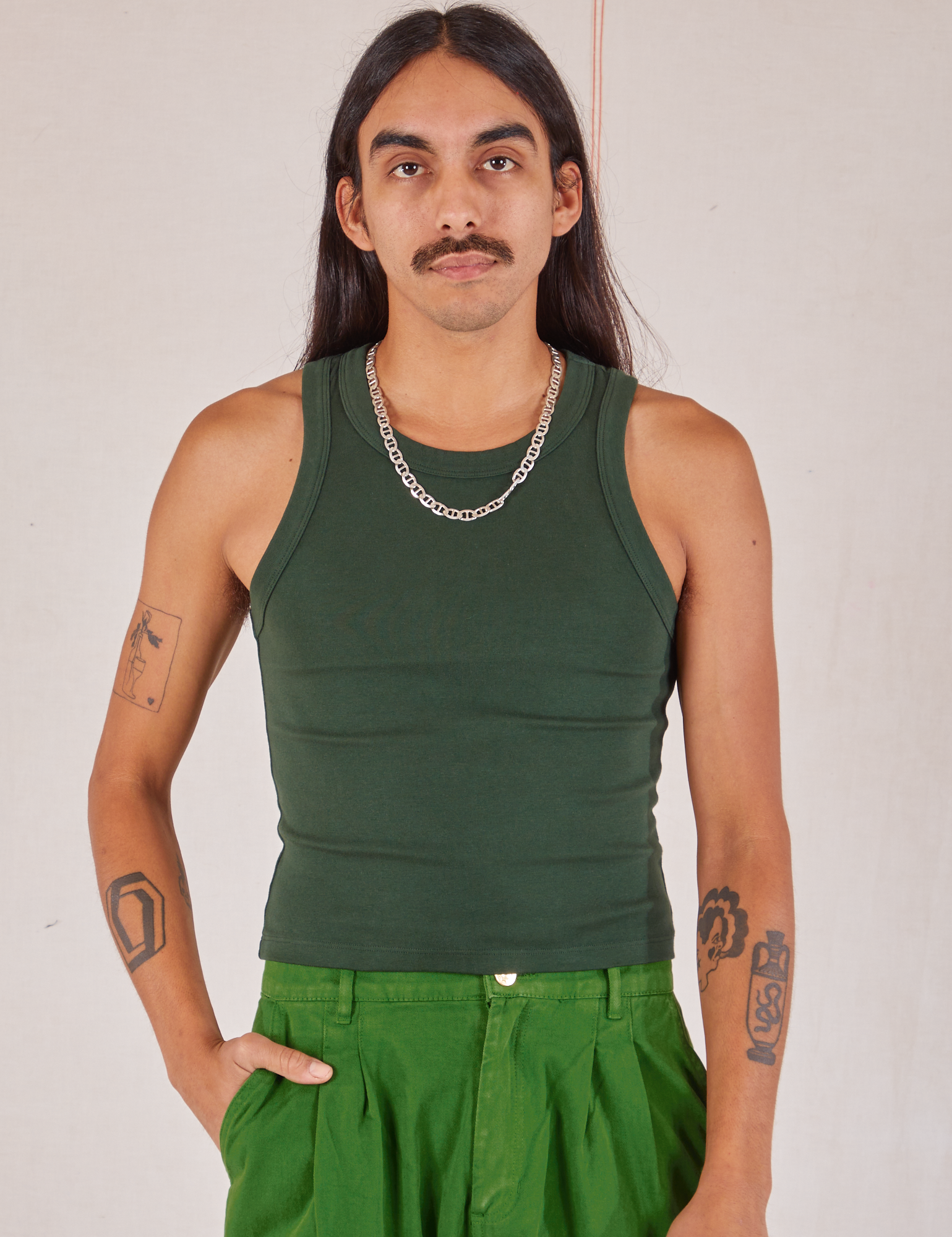 Anthony is 5’10” and wearing S Racerback Tank in Swamp Green