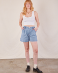 Margaret is 5'11" and wearing XS Denim Trouser Shorts in Light Wash paired with a Cropped Tank in vintage tee off-white