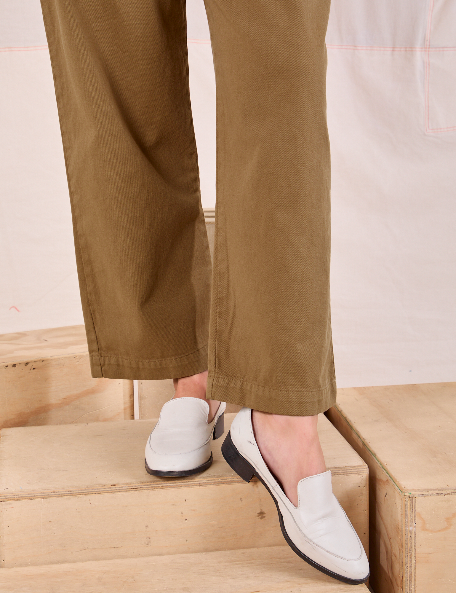 Mid-Rise Pleated Trousers in Desert Brown pant leg close up on Alex