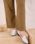 Mid-Rise Pleated Trousers in Desert Brown pant leg close up on Alex