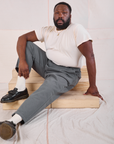 Elijah is wearing Mid-Rise Work Pants in Slate Grey and Organic Vintage Tee in vintage tee off-white