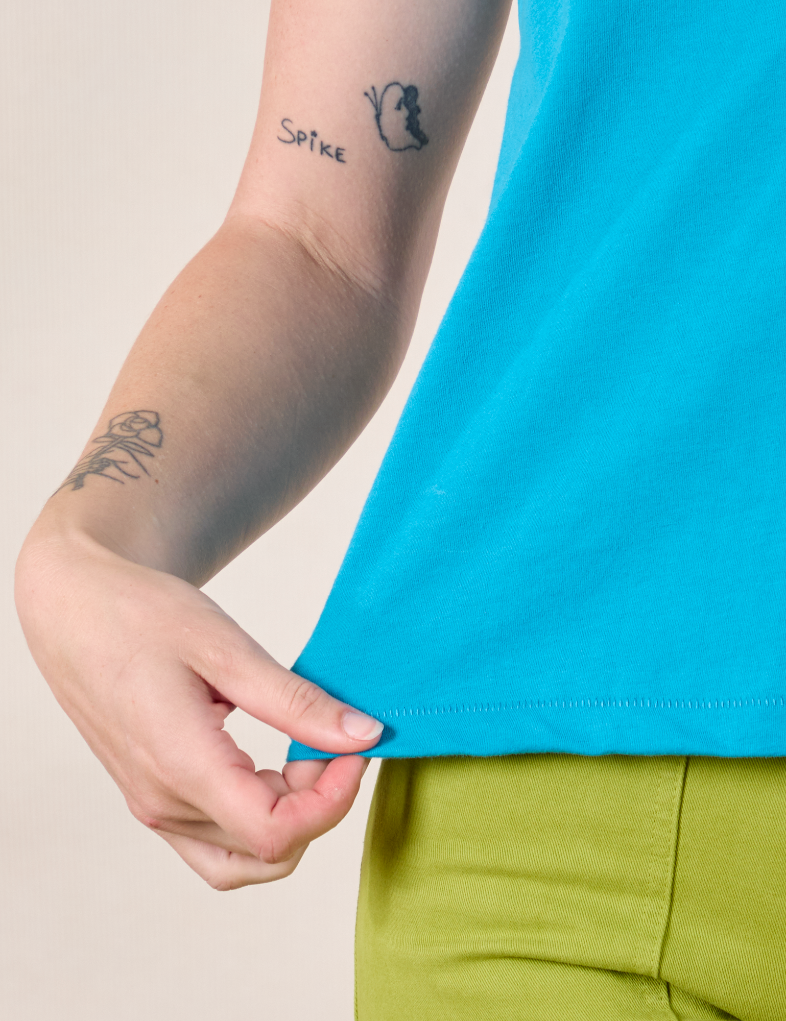 Mismatched Tee in Blue &amp; Green bottom hem close up on Alex