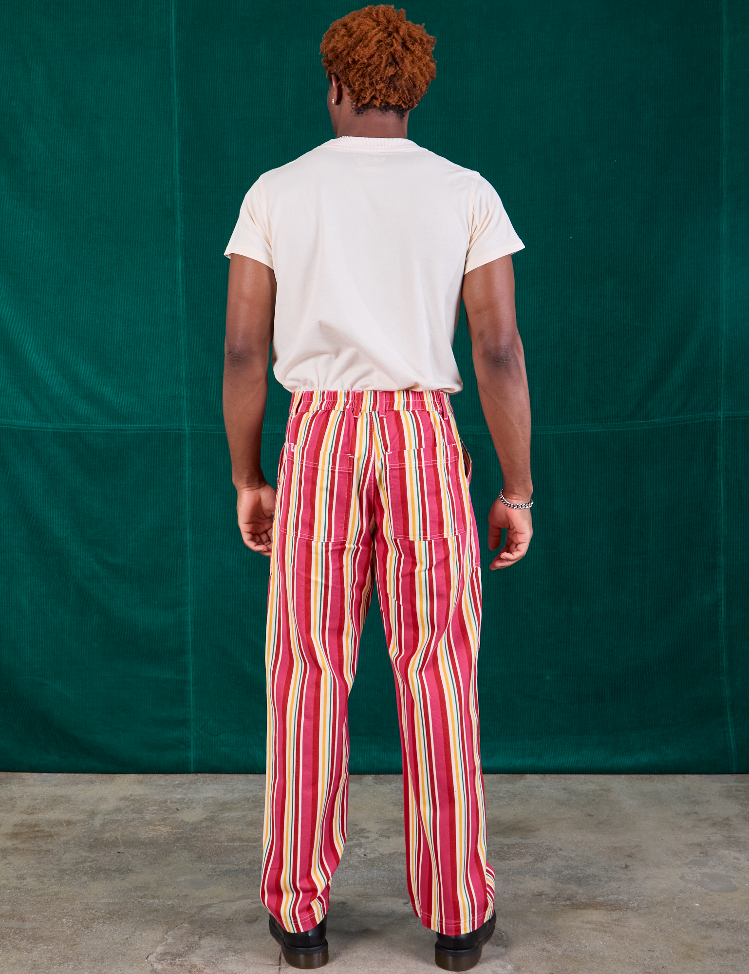 Back view of Stripe Work Pants in Cherry Candy and Organic Vintage Tee Off-White on Issac