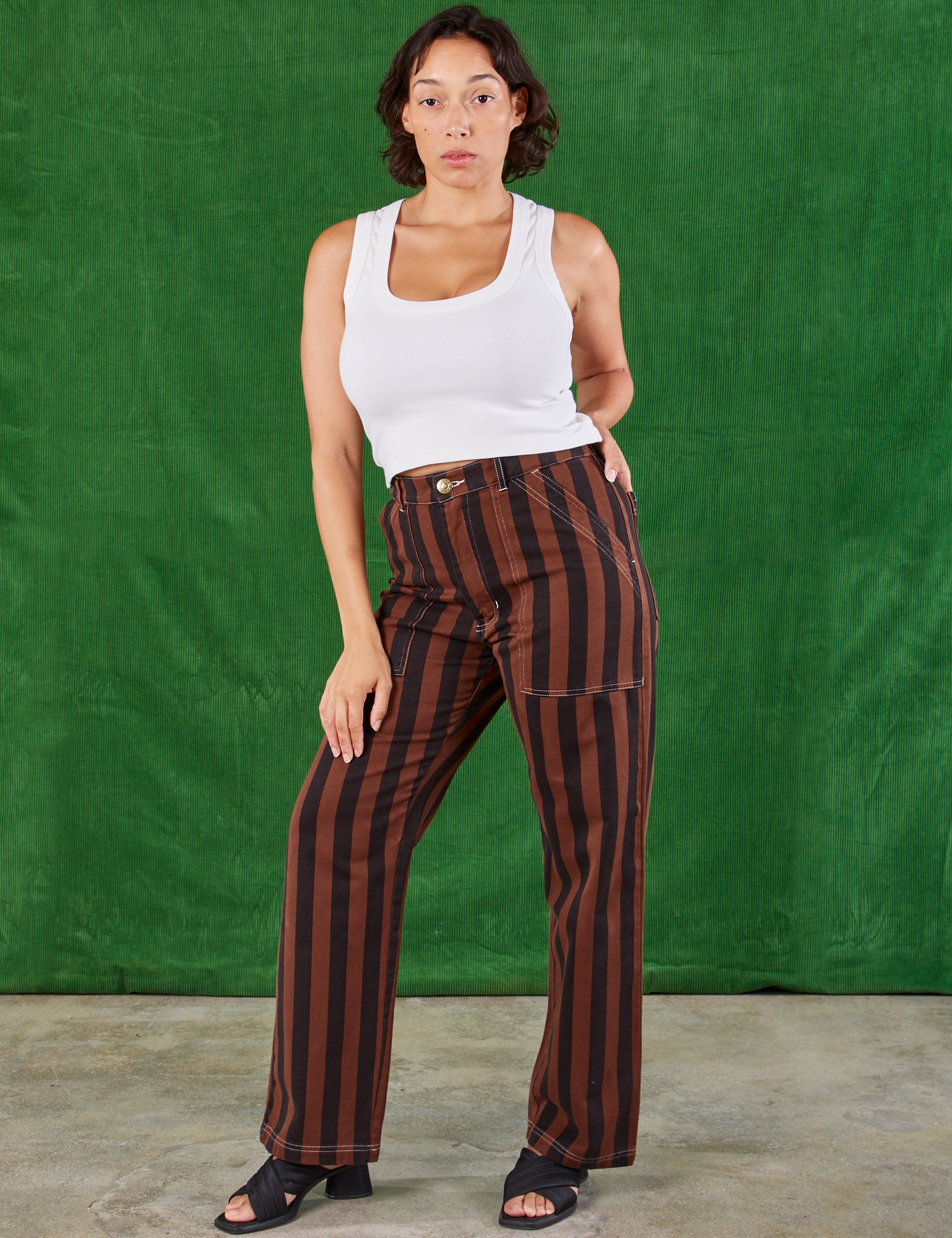 Tiara is wearing Black Stripe Work Pants in Fudgesicle Brown and Cropped Tank in vintage tee off-white