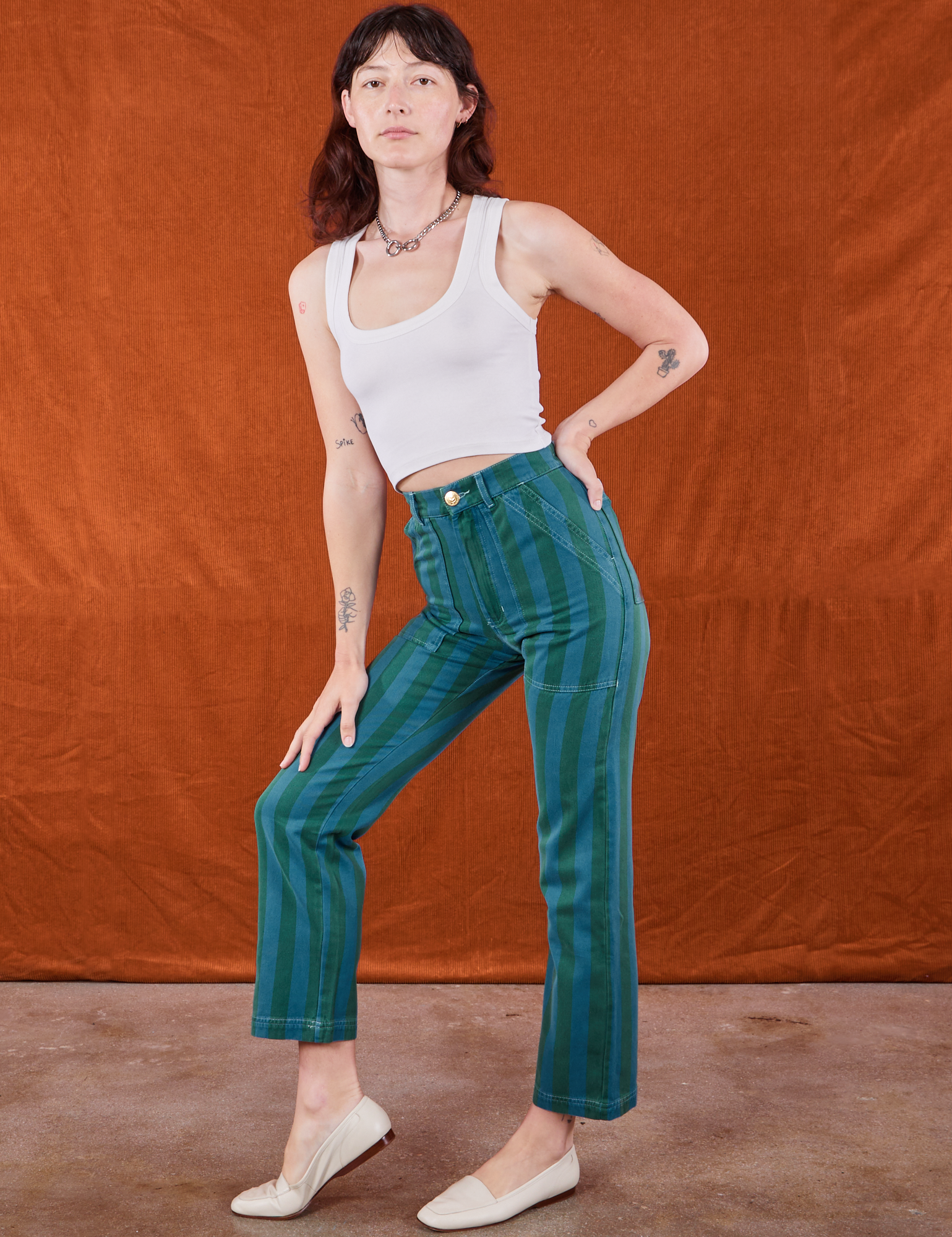 Alex is 5&#39;8&quot; and wearing XS Overdye Stripe Work Pants in Blue/Green paired with vintage off-white Cropped Tank Top