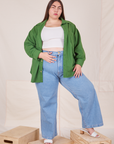 Marielena is wearing Oversize Overshirt in Lawn Green paired with vintage off-white Cropped Tank Top and light wash Sailor Jeans