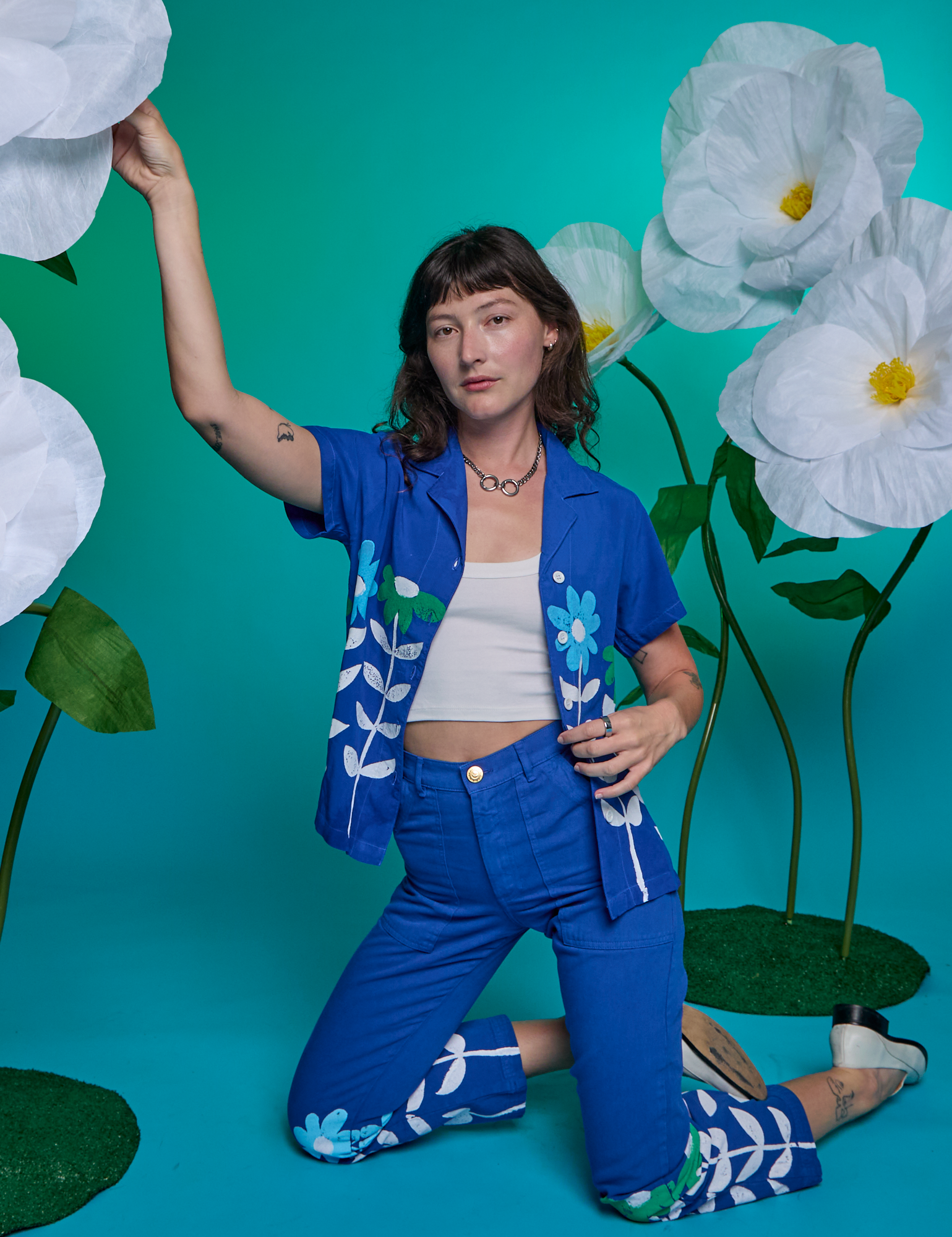 Alex is wearing Paintstamped Work Pants in Daisy and matching Pantry Button-Up