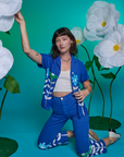 Alex is wearing Paintstamped Work Pants in Daisy and matching Pantry Button-Up