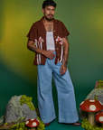 Jesse is wearing Paintstamped Pantry Button-Up in Mushroom and light wash Indigo Wide Leg Trouser
