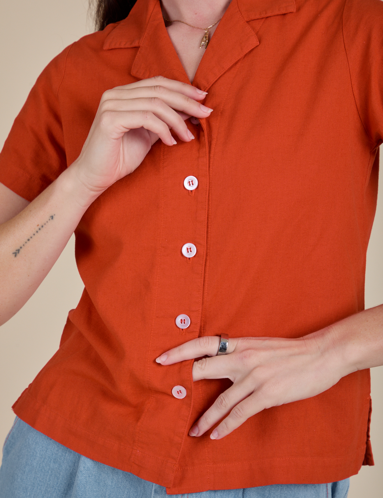Front close up of Pantry Button-Up in Chili Red with white buttons on Alex