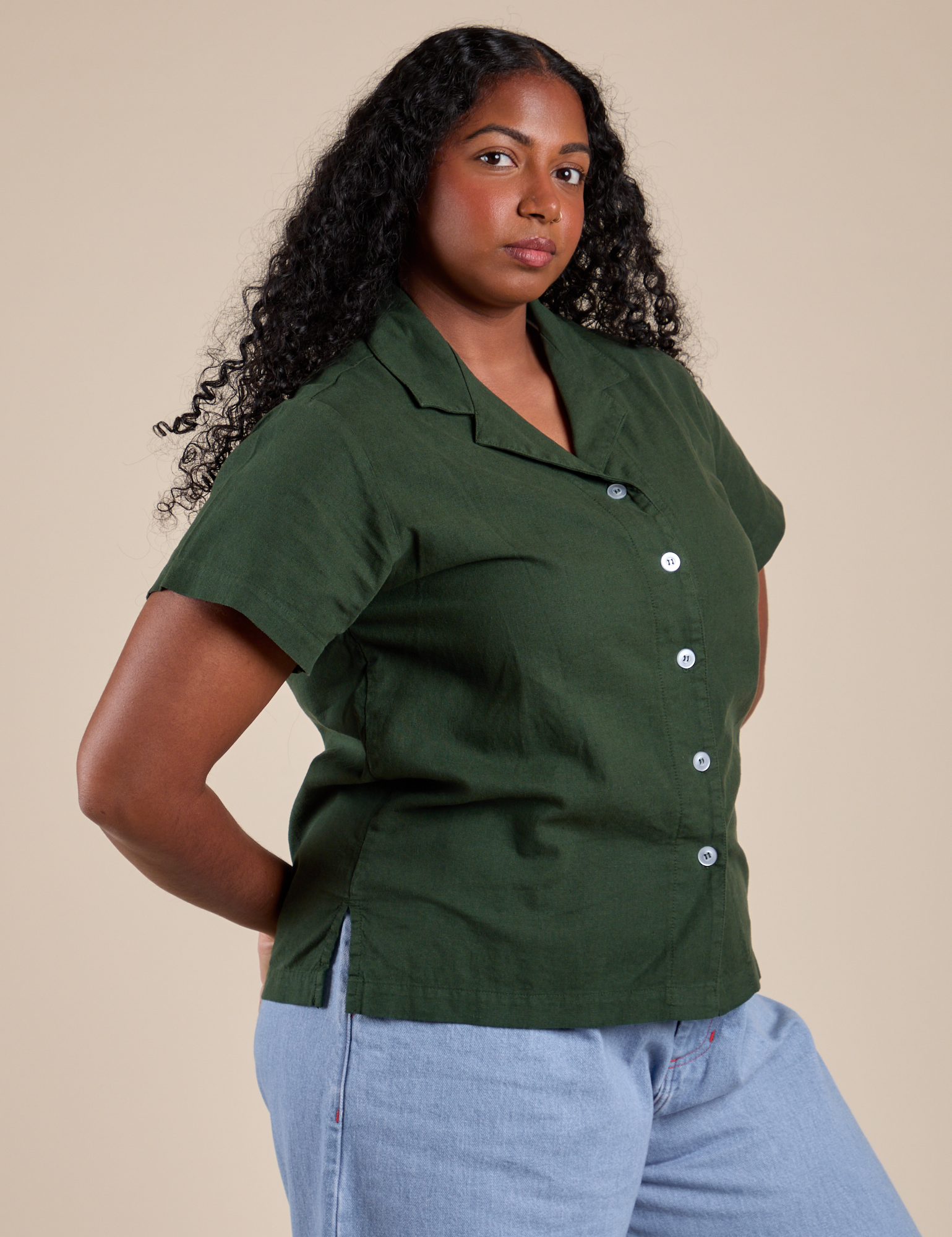 Angled front view of Pantry Button-Up in Swamp Green on Meghna