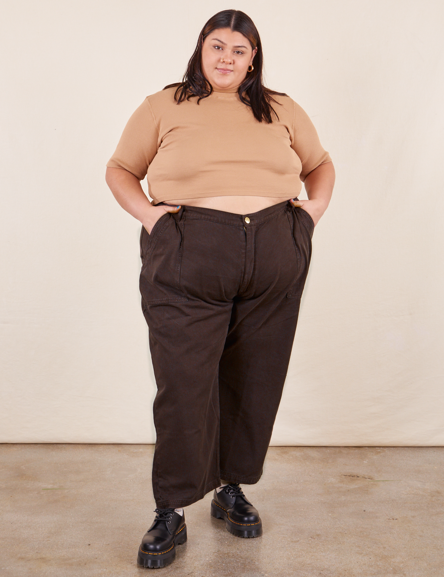 Sarita is 5&#39;7&quot; and wearing Petite 4XL Work Pants in Espresso Brown paired with 1/2 Sleeve Turtleneck in Tan