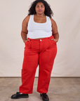 Morgan is 5'5" and wearing 2XL Work Pants in Mustang Red paired with a Cropped Tank in Vintage Tee Off-White