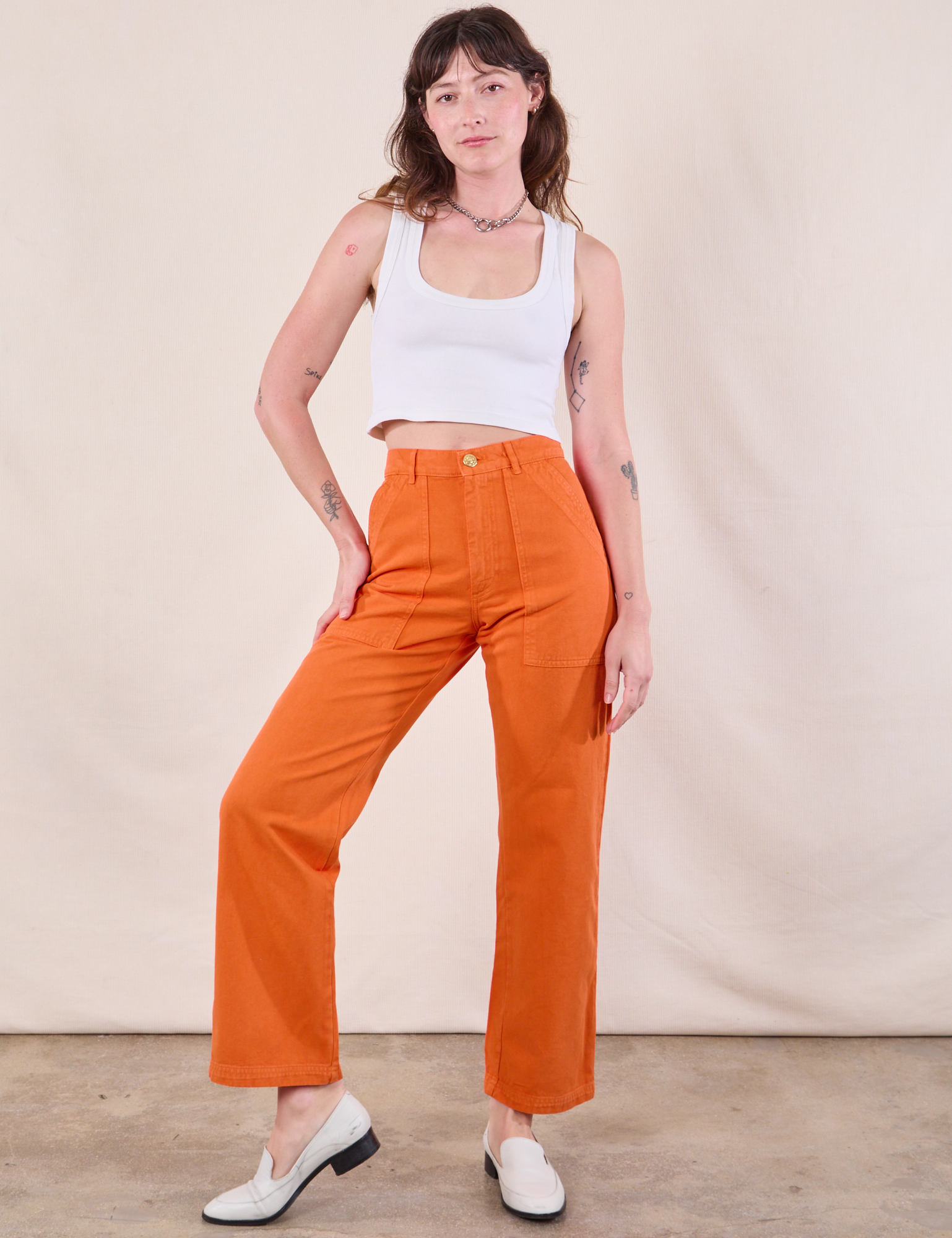 Alex is 5&#39;8&quot; and wearing XXS Work Pants in Construction Orange paired with a Cropped Tank in Vintage Tee Off-White