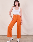 Alex is 5'8" and wearing XXS Work Pants in Construction Orange paired with a Cropped Tank in Vintage Tee Off-White