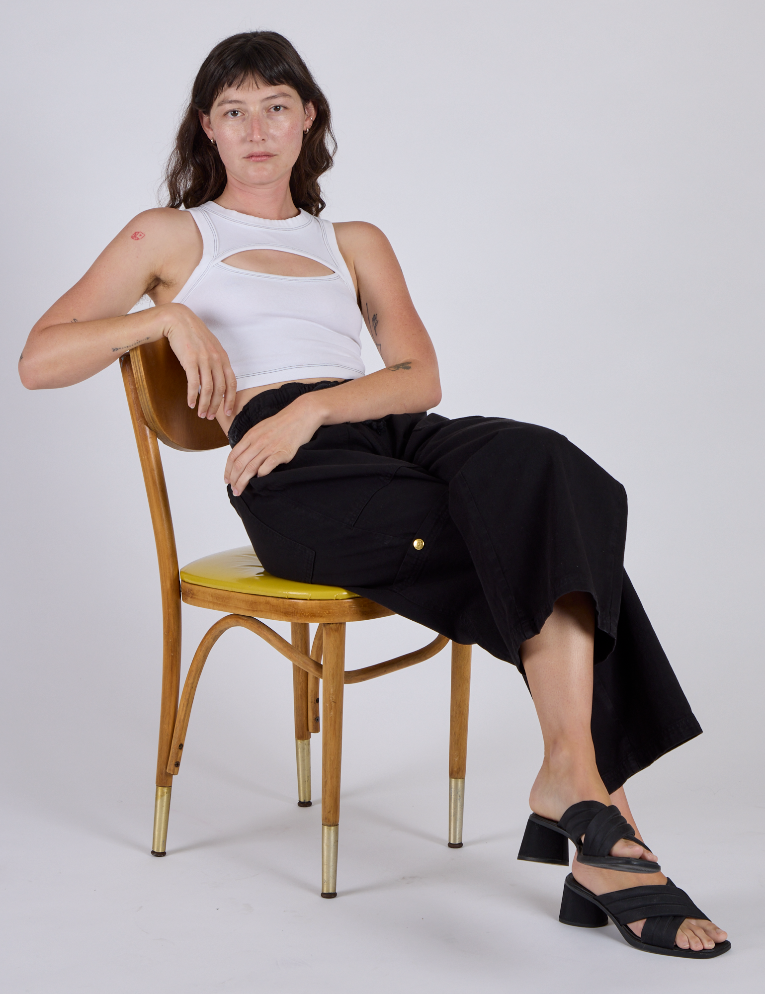 Alex wearing the Vintage Tee White Porthole Tank with Black Drop Pocket Cargo Pants