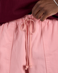 Close up of Drop Pocket Cargo Pants in Baby Pink drawstring on Isaac