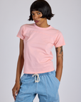 Kira is 5’10” and wearing P Jr. Varsity Tee in Baby Pink