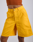 Close up of Longline Work Shorts in Sunshine Yellow on Kira
