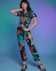 Alex is 5'8" and wearing XS Short Sleeve Jumpsuit in Rainbow Magic Waters