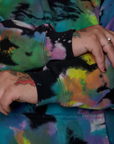 Sleeve close up of Oversized Hoodie in Rainbow Magic Waters on Sam