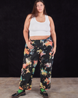 Katie is 6'2" and wearing 3XL Rainbow Magic Waters Work Pants paired with a vintage off-white Cropped Tank