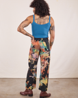 Back view of Rainbow Magic Waters Work Pants and marine blue Cropped Tank worn by Jesse