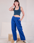 Alex is wearing Mid-Rise Pleated Trousers in Royal Blue and lagoon Cropped Tank