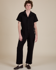 Quinn is 6'3" and wearing L Short Sleeve Jumpsuit in Basic Black