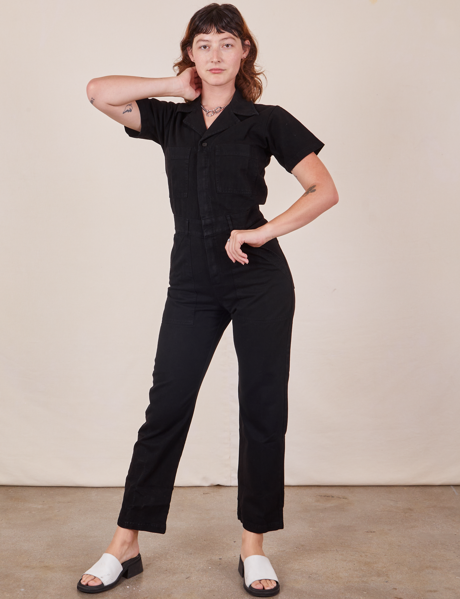 Alex is 5&#39;8&quot; and wearing XS Short Sleeve Jumpsuit in Basic Black