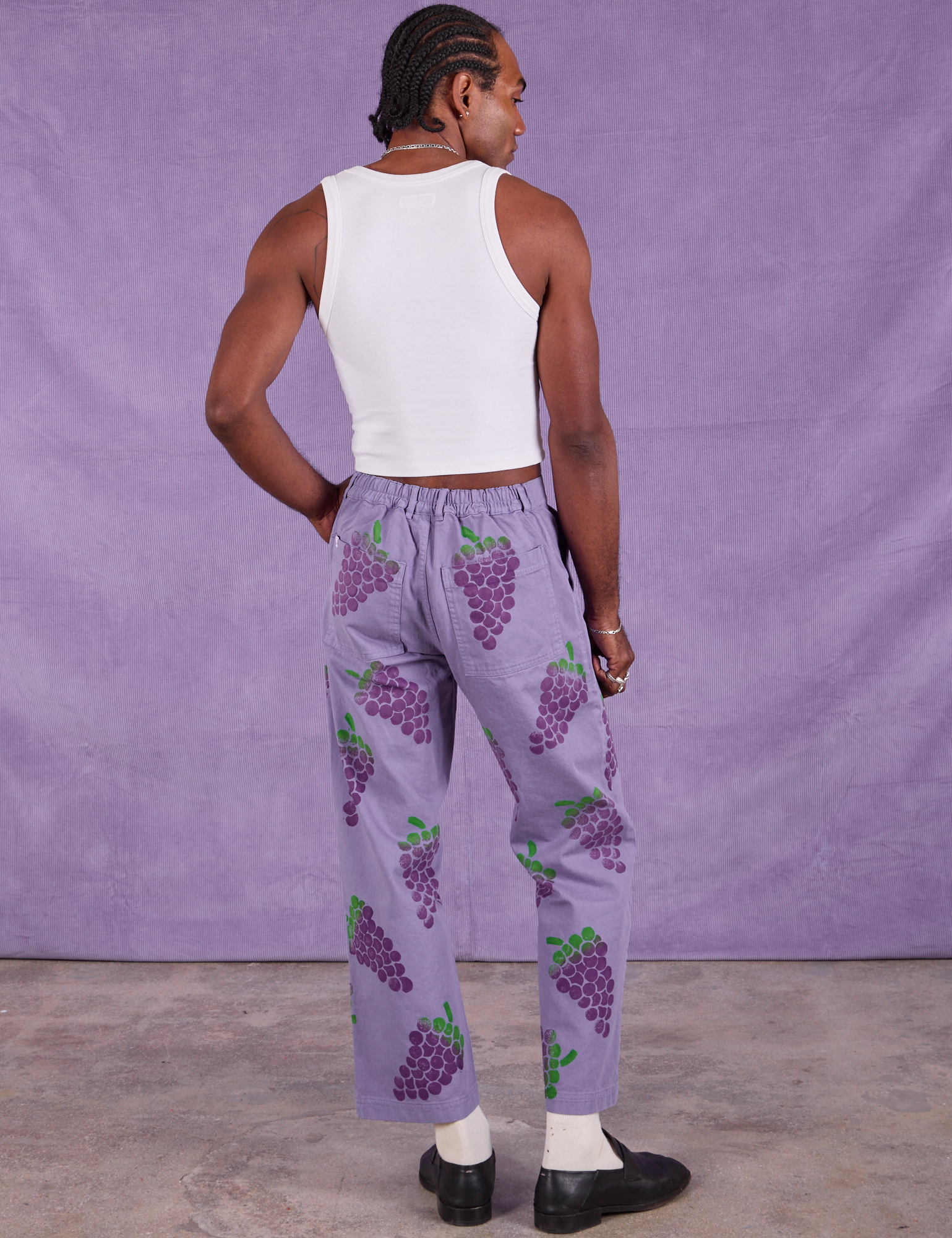 Back view of Paintstamped Work Pants in Grape and Cropped Tank in Vintage Tee Off-White on Jerrod