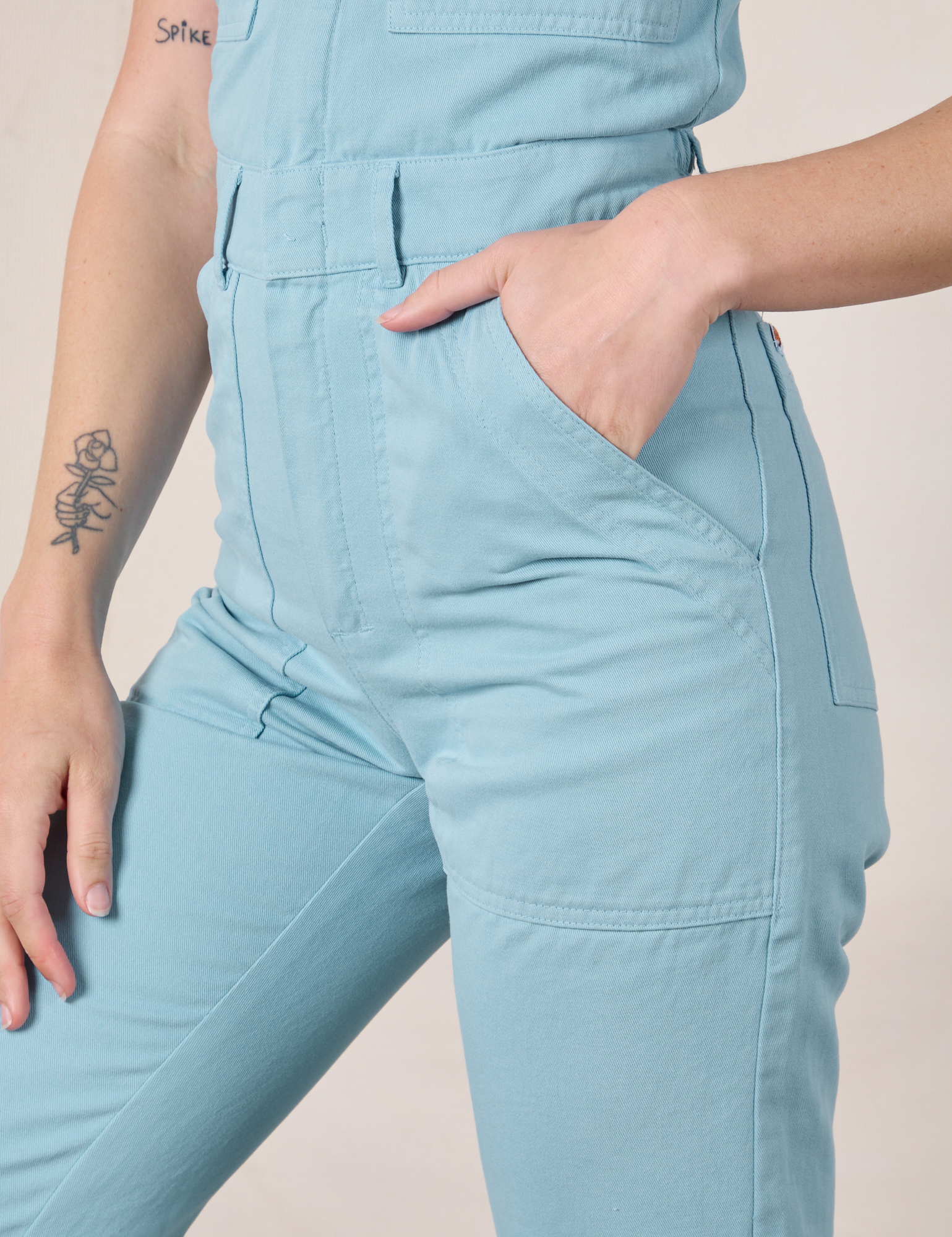 Short Sleeve Jumpsuit in Baby Blue side close up with Alex&#39;s hand in the pocket