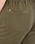 Short Sleeve Jumpsuit in Surplus Green back pocket close up on Bree