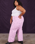 Side view of Star Bell Bottoms in Lilac Purple and Cropped Tank in vintage tee off-white on Morgan