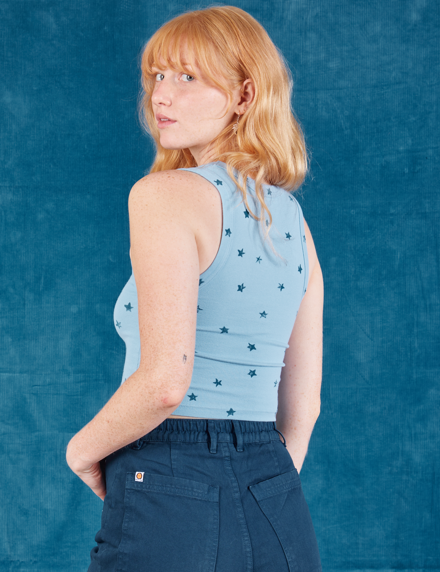 Angled back view of Star Cropped Tank on Margaret